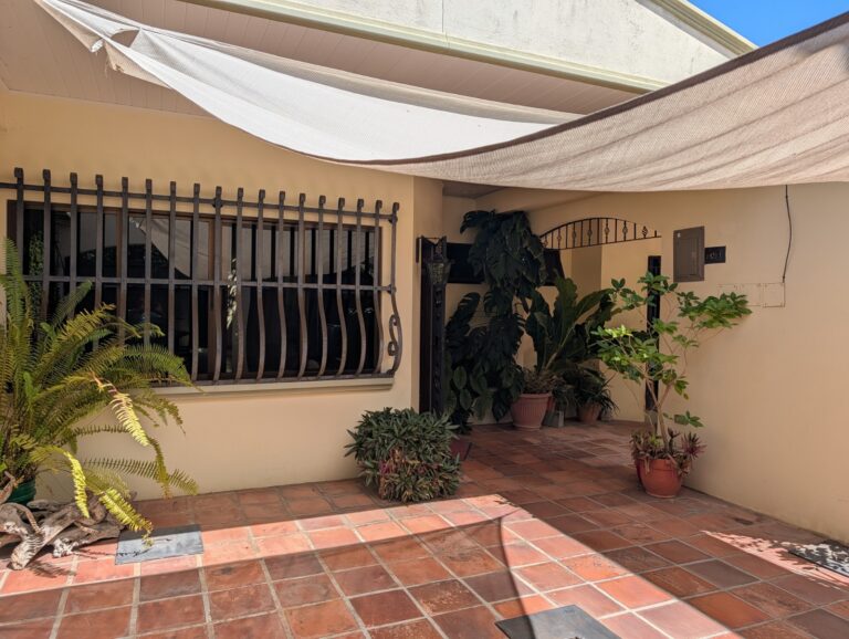 Private courtyard patio at Villa Cabomar West Villa Puntarenas Costa Rica with tiled flooring, shade canopy and tropical plants